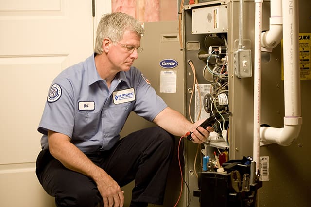 Technician adjusting a water heater