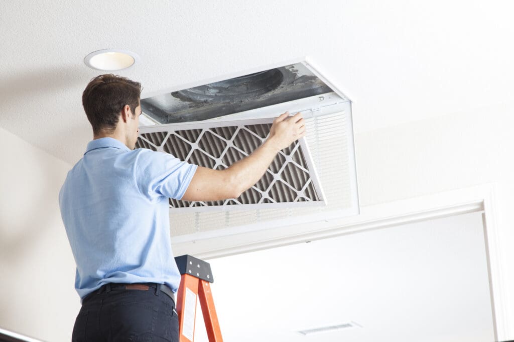 HVAC conractor changing air filter